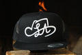 LA SHAPES LOGO BLACK TRUCKER HAT